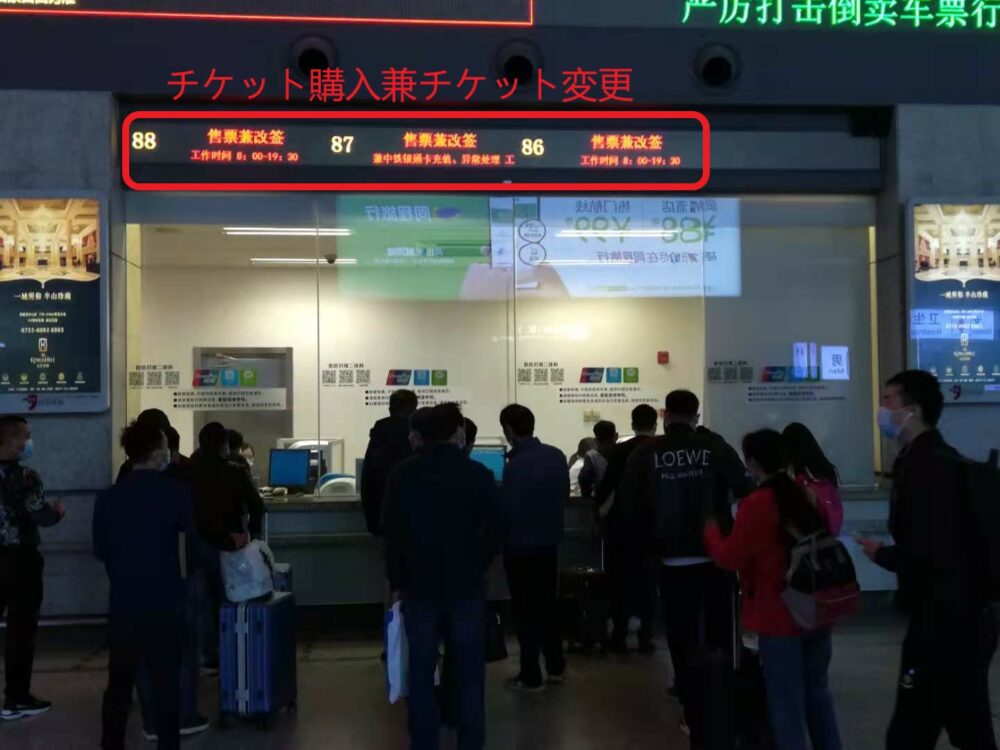售票兼改签(チケット購入兼チケット変更)の列に並び、チケットを購入しているときの様子の写真